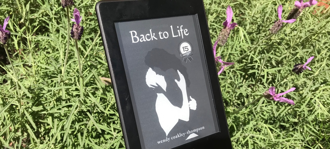 kindle image of cover with black woman and white man embracing, lavender in background