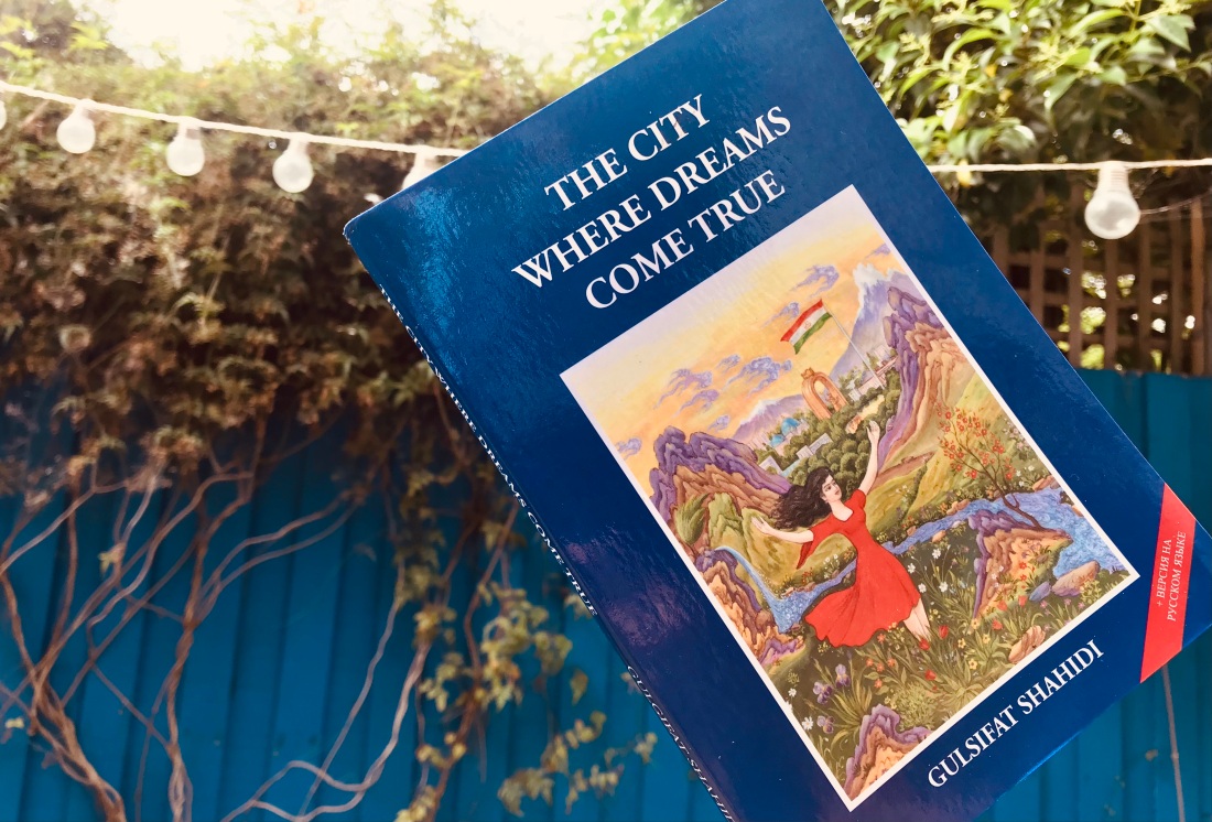 book cover with woman in red dress in beautiful countryside