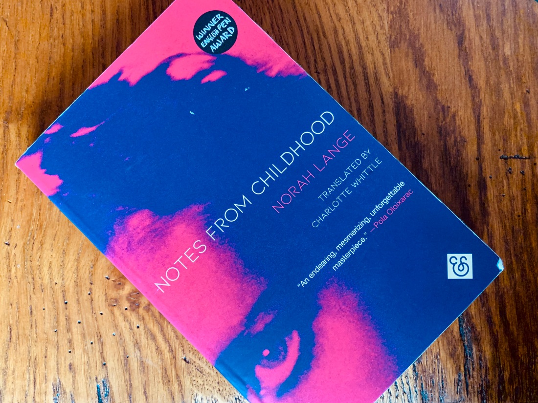 pink and blue book cover with corner of woman's face